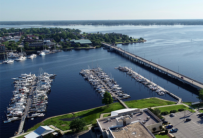 Several boats docked near a bridge in beautiful New Bern.