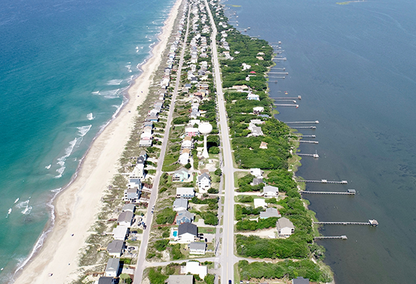 An aerial view of Emerald Isle, surrounded by two shades of water on both sides.